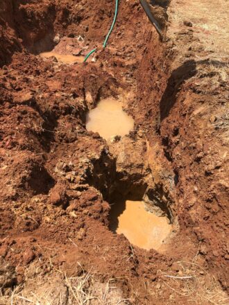 Ceylon sapphire rough stones being unearthed by small-scale miners